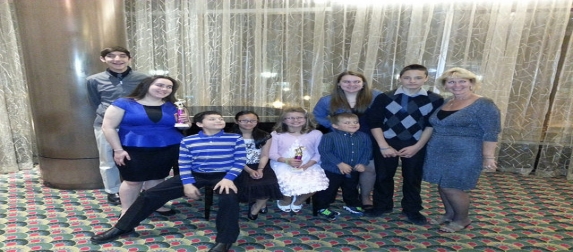 Young people from the church dressed up, several holding awards