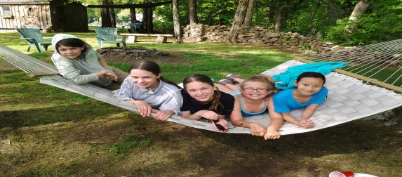 Children from the church sharing a hammock outdoors